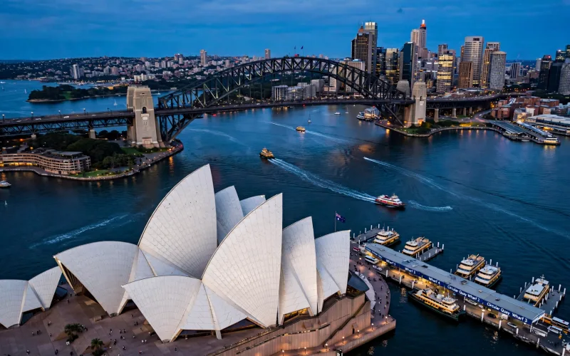 Sydney Opera House and Harbour Bridge across Sydney Harbour at dusk