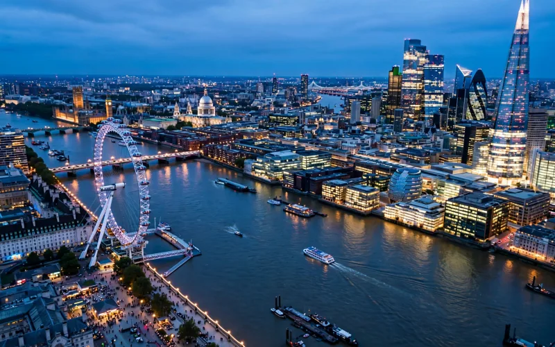 London skyline over the Thames with London Eye and The Shard at blue hour