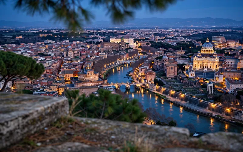Rome skyline over St. Peter's Basilica and the Tiber at blue hour