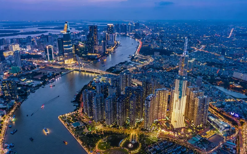 Ho Chi Minh City skyline over the Saigon River and Landmark 81 at blue hour
